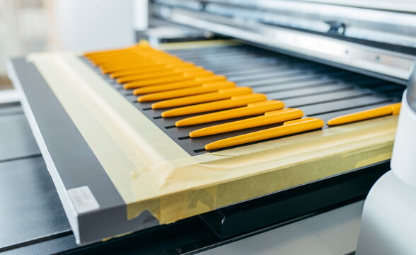 Yellow ballpoint pens, mock up. Large format UV flatbed printer for printing on all kind of rigid material. 