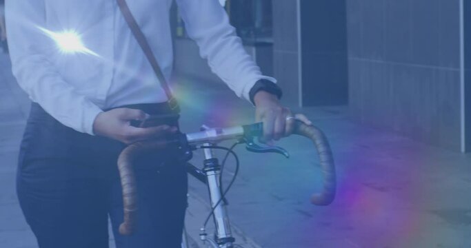 Animation of light spots over biracial man using smartphone