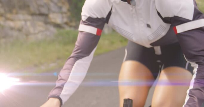 Animation of light spots over caucasian woman cycling
