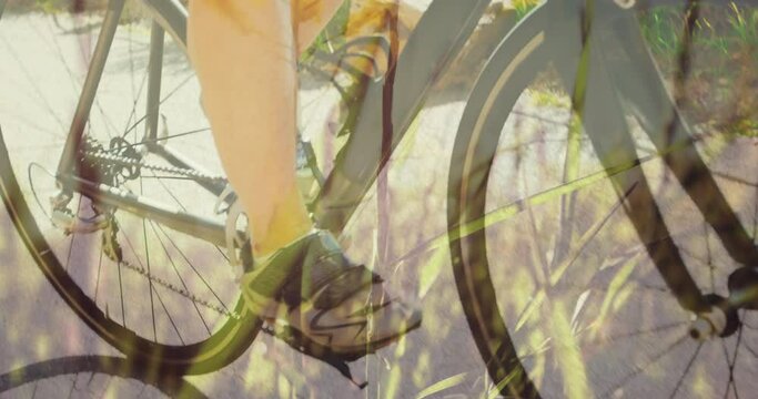 Animation of grass over caucasian woman cycling