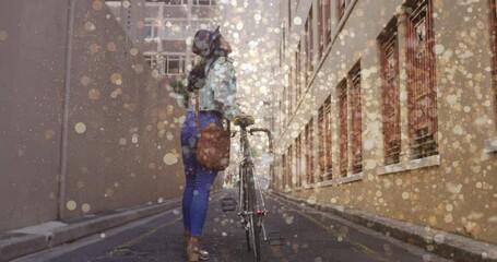 Animation of light spots over biracial woman walking with bicycle