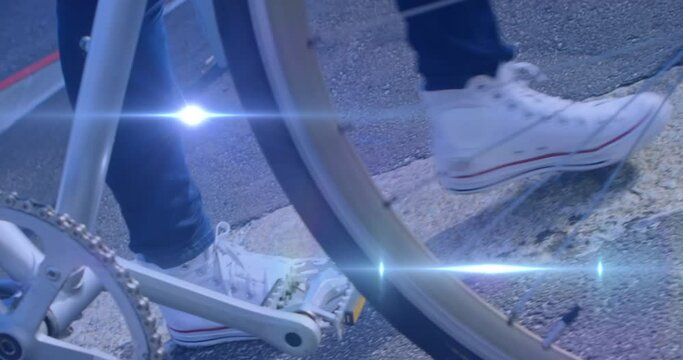 Animation of light spots over woman walking with bicycle - Powered by Adobe