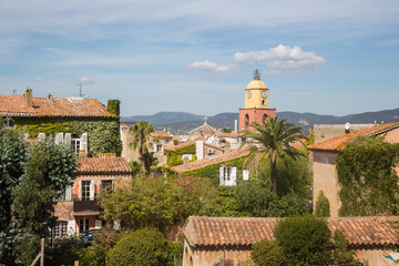 View over the roofs to the clock tower of the church Our Lady of the Assumption of the famous and glamourous village Saint Tropez, Provence, Côte d' azur, France