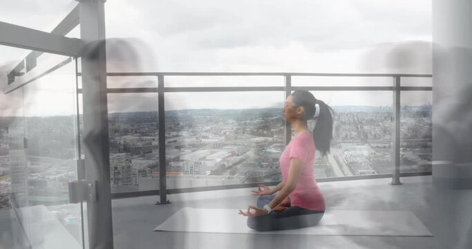 Animation of walking people over asian woman practicing yoga and meditating