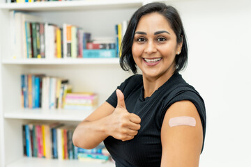 Pretty latin american mature woman with plaster after vaccination