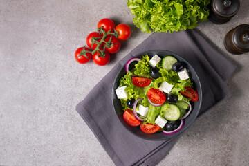 Greek salad with fresh tomatoes, cucumber, olives, feta cheese and red onion. Healthy and diet food concept.