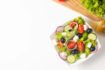 Greek salad with fresh tomatoes, cucumber, olives, feta cheese and red onion. Healthy and diet food concept.