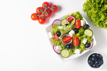 Greek salad with fresh tomatoes, cucumber, olives, feta cheese and red onion. Healthy and diet food concept.