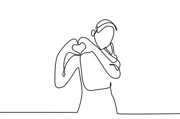 a person is making and showing a heart sign with her hands
