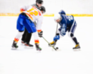 Naklejka na ściany i meble Defocused confrontation of hockey players on ice during the match - referee throwing the puck on point - rivalry in sports