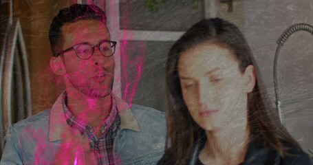 Animation of pink flame over caucasian couple arguing