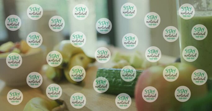 Animation of stay natural texts icons over vegetables