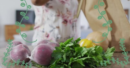 Animation of plant icons over caucasian woman with vegetables