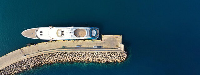 Aerial drone top view ultra wide panoramic photo with copy space of luxury yacht anchored in...