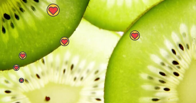 Animation of heart icons over kiwi fruit