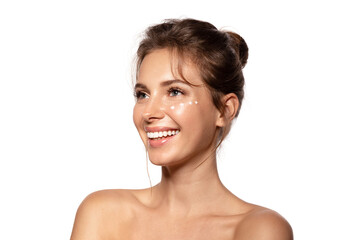 Smiling woman  with moisturizing cream on the cheek. Beauty portrait  with bare shoulders. Beauty...