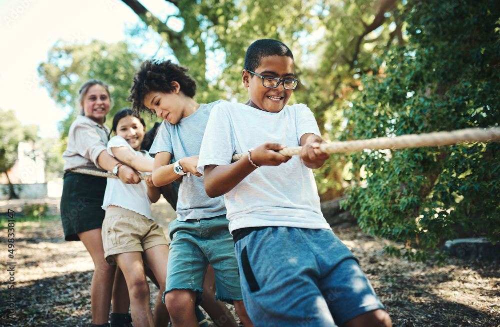 Canvas Prints were all winning when were playing together. shot of a group of teenagers playing a game of tug of w