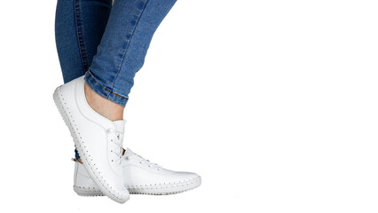 Women Leg Jeans and white sports Sneakers isolated on white background