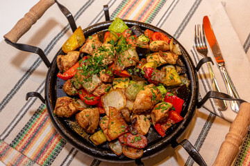 Pan-fried potatoes, meat and vegetables for a large company