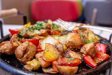 Pan-fried potatoes, meat and vegetables for a large company