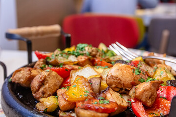 Pan-fried potatoes, meat and vegetables for a large company