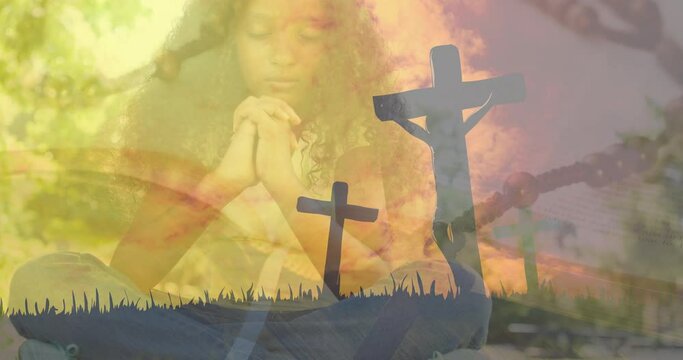 Animation of crosses over african american girl praying