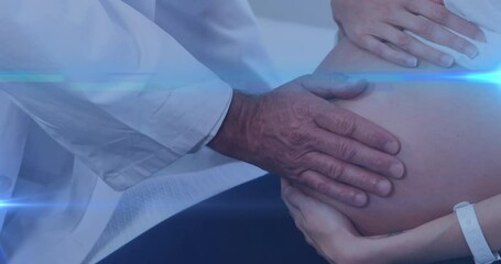 Animation of light spots over biracial doctor with caucasian pregnant woman