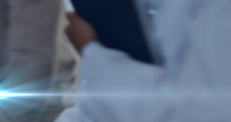 Animation of light spots over biracial pregnant woman with nurse and husband in hospital