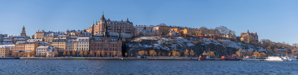 Fototapeta premium Block with old 1700s houses a snowy spring day in Stockholm