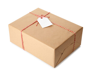 Gift box wrapped in kraft paper with bow and tag isolated on white