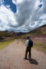 Hiker in the high elevation region of Rainbow Mountain region of Cusco, Peru