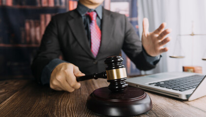 Business and lawyers discussing contract papers with brass scale on desk in office. Law, legal services, advice, justice and law concept picture with film grain effect