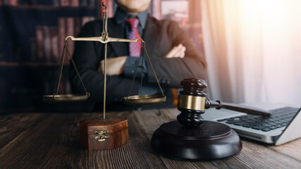 Business and lawyers discussing contract papers with brass scale on desk in office. Law, legal services, advice, justice and law concept picture with film grain effect