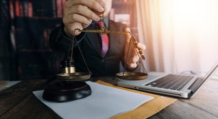 Business and lawyers discussing contract papers with brass scale on desk in office. Law, legal services, advice, justice and law concept picture with film grain effect