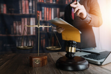 Business and lawyers discussing contract papers with brass scale on desk in office. Law, legal services, advice, justice and law concept picture with film grain effect