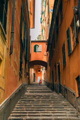 Fototapeta na wymiar Stairs in a narrow Italian street. Colorful streets in Genoa.
