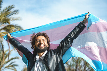 Happy man with transgender flag - obrazy, fototapety, plakaty