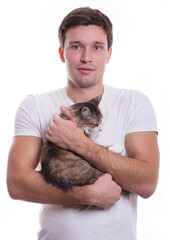 young white cute man tenderly holds a cat in his hands on a white background