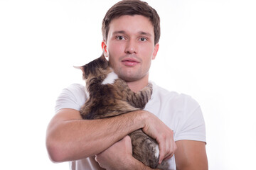 young white cute man tenderly holds a cat in his hands on a white background