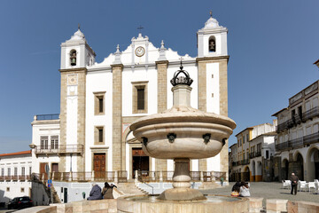 Fountain and Santo Antao Church at Giraldo Square in Evora, Portugal