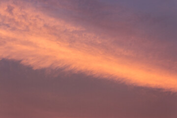 glowing clouds on the red sky in evening light. dramatic weather in summer at dusk