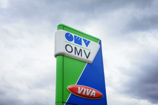 Prague, Czech Republic, Czechia - April 7, 2022: OMV gas and petrol station. Advertising pylon with brand logo. Cloudy sky and copy space.