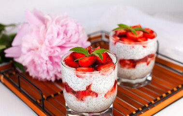 Healthy and delicious breakfast of ripe strawberry, yogurt and chia seeds on a wicker tray. Healthy food concept. ?lose-up. Banner.