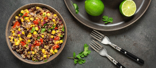Mexican food. Salad with black beans, corn and quinoa in a bowl on a dark grunge background. Top view, flat lay. Selective focus. Banner