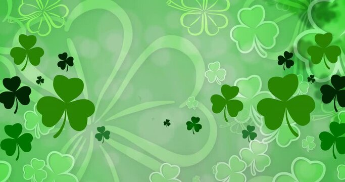 Animation of multiple clover leaves on green background