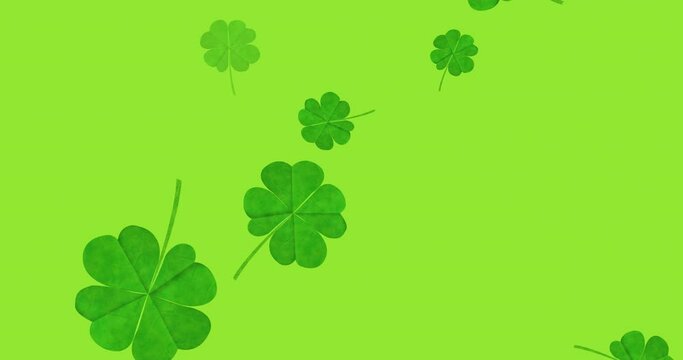 Animation of multiple clover leaves falling on green background
