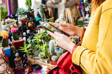 unrecognizable woman at a crafts fair buying merchandise making payments from the mobile