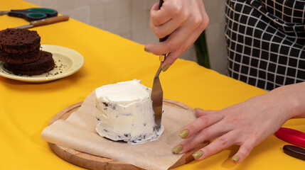 The bento cake is covered with white cream using palette knife. Picture for websites about...