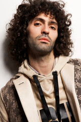 Fashion Model Posing, And  and Looking Confident In Studio, Standing against the wall