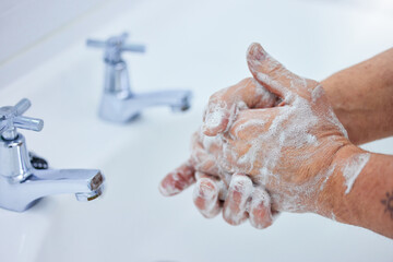 Fototapeta premium Keep your hands clean. Shot of an unrecognizable man washing his hands with soap at home.